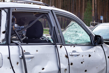 Car riddled with bullets. War of Russia against Ukraine. A car of civilians shot by the Russian...