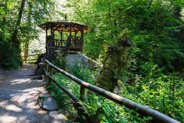 Wooden arbor near flowing Kamenice river in the Bohemian Switzerland National Park, Czech Republic