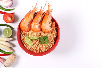 Instant noodles spicy tom Yum kung. Tom Yum kung in a red bowl with ingredients placed on a white background top view.