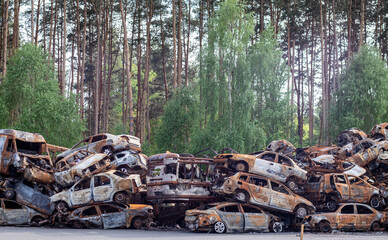 A lot of rusty burnt cars in Irpen, after being shot by the Russian military. Russia's war against...