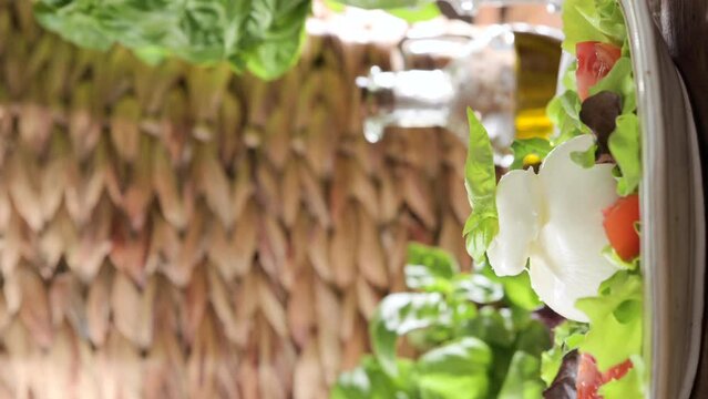 Salad with Tomatoes, Burrata, basil,olive oil. middle name Burratina. Traditional cheese from the south of Italy in the Puglia region. Round soft cheese inside liquid stracciatella texture.4k.vertical