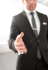 businessman holding out his hand for a handshake