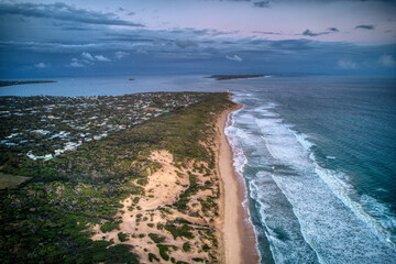 Aerial view along the coast looking towards the lighthouse, and Port Philip Bay heads towards Point Nepean. Victoria, Australia. May 2022