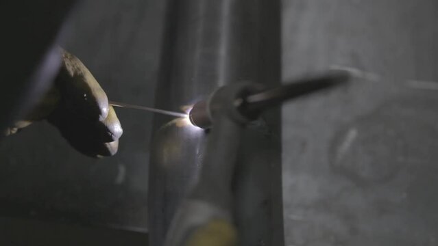 Professional Heavy Industry Welder working in industrial production factory. welding worker wearing helmet. Industrial Process, Heat Electrode Work. Metalwork Assembly, Construction