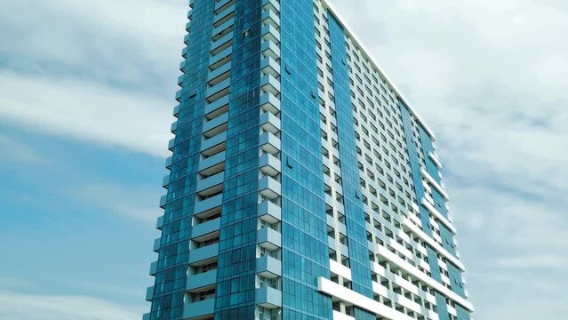 Newly built building. Part of modern residential apartment with exterior of flat building. Detail of New elite house and home complex. Fragment of urban real estate and condominium architecture.