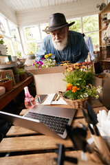 Male florist packing online orders in shop