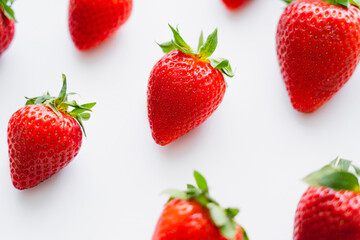 High angle view of ripe strawberries on white background.