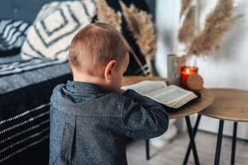 Child pray and read Bible in his room, religious concept