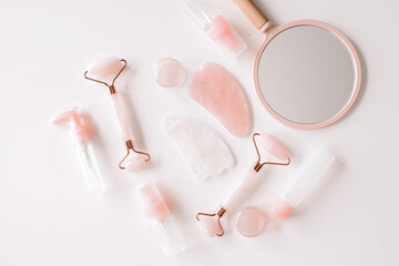 Set of face rollers and gua sha on a white background