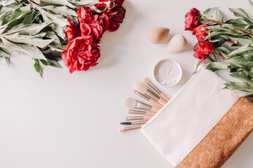 Bottles of cosmetic products, face roller and gua sha massager, cosmetic bag, brushes and sponge on a white isolated background. Banner.  Spa vacation, body care, spa, skin care concept.