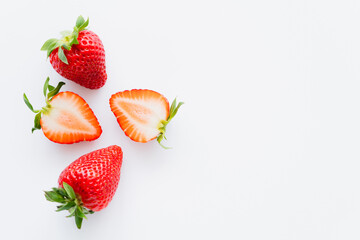 Top view of red ripe strawberries on white background.