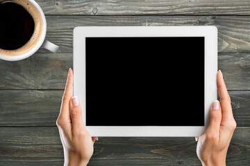 tablet computer with blank screen and cup of tea or coffee