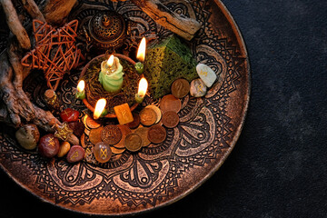 Witch altar with candles, old coins, stone runes, minerals, pentacle on dark table background....