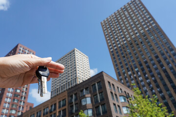 Apartment keys witn a new modern residential buildings in the background