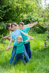 Fototapeta premium Grandmother and grandchildren, playing together in the park, spring