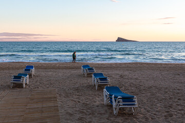 Beach loungers collected on the Levante beach in Benidorm, Alicante, Spain