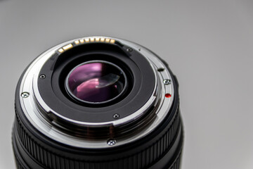 Back side of a dslr camera lens objective for professional photography with camera mount details in...