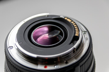 Back side of a dslr camera lens objective for professional photography with camera mount details in macro view with beautiful lens details for optical precision in portrait photography