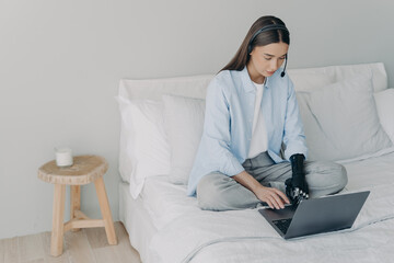 Handicapped remote manager or assistant. Concentrated girl has online meeting at home.