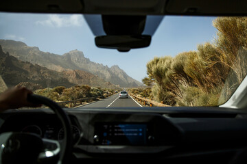 View from the cab of the auto. Driving a car on a mountain road.