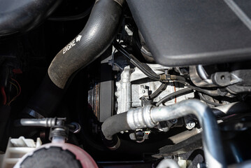 Air conditioning compressor in passenger car with diesel engine, located in the engine compartment.