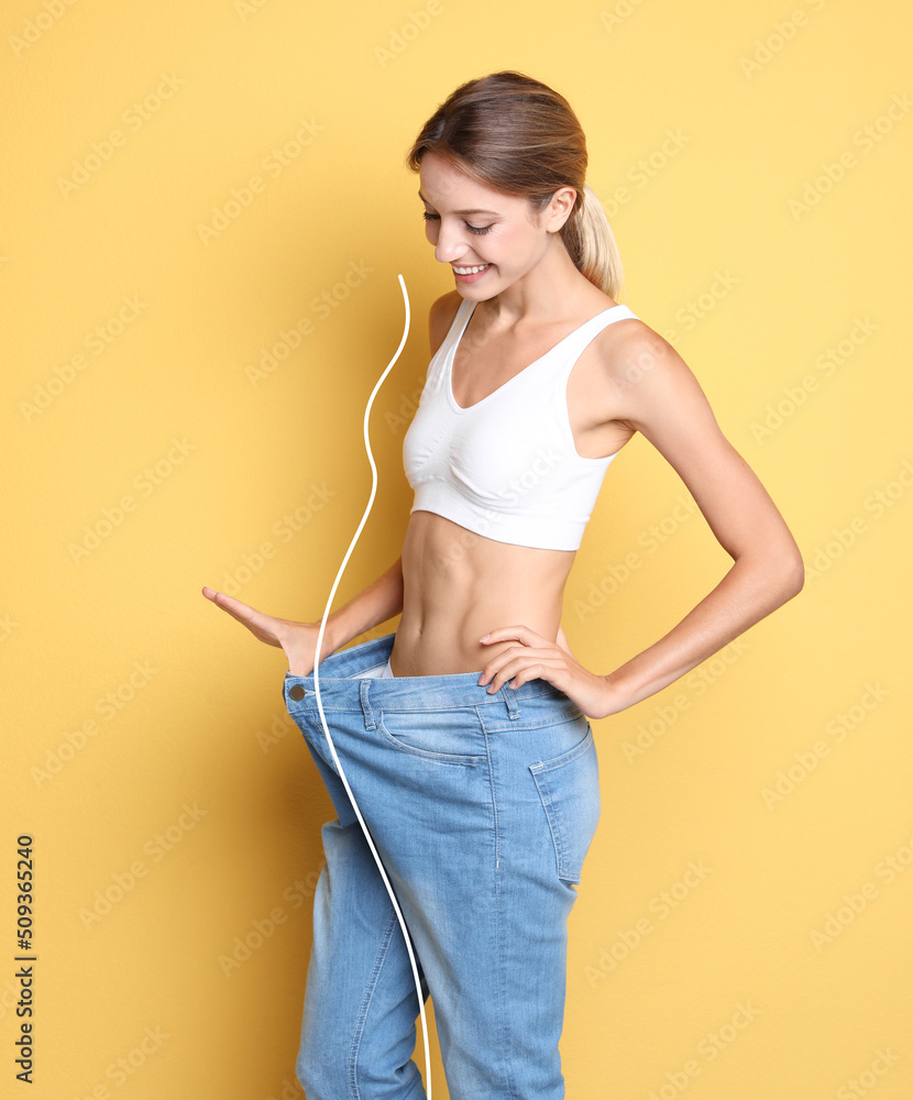 Sticker Happy young woman with slim body in oversized jeans on yellow background. Weight loss