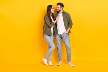Full length photo of adorable couple wear matching clothes hug embrace each other isolated on yellow color background