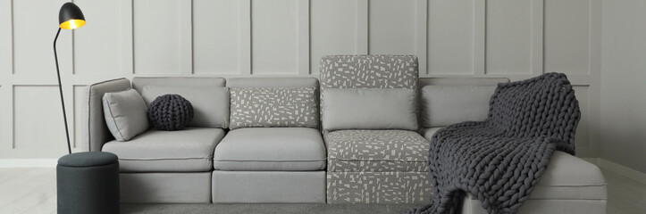 Living room interior with comfortable sofa near molding wall. Banner design