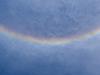 Rainbow halo around the sun in the sky. Natural phenomenon