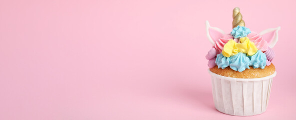 Cute sweet unicorn cupcake on pink background, space for text. Banner design © New Africa