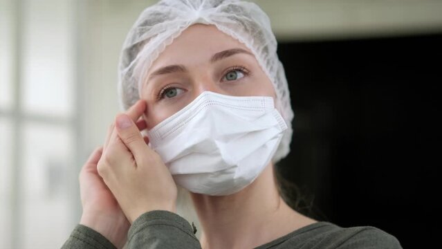 Adorable girl putting on face safety medical mask prevention infection disease. medical guards. Ready to receive patients in hospital. Health care, medical concept.