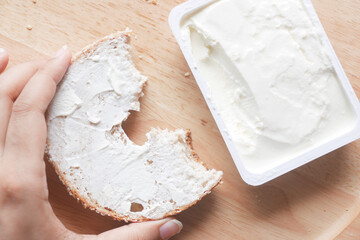 cheese cream spread on fresh bagel bread 