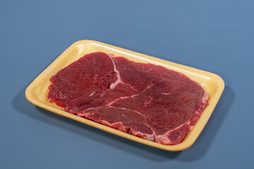 red meat beef in yellow foam board