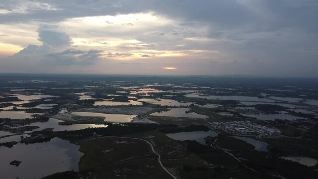 Fly toward abandoned tin mining lake Kampar, Perak in sunset hour
