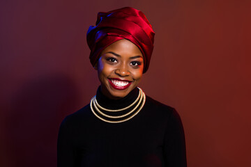 Portrait of attractive cheerful woman wearing traditional look outfit isolated over dark red maroon color background