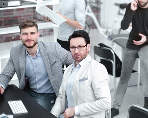 employee talking on a mobile while sitting on office Desk