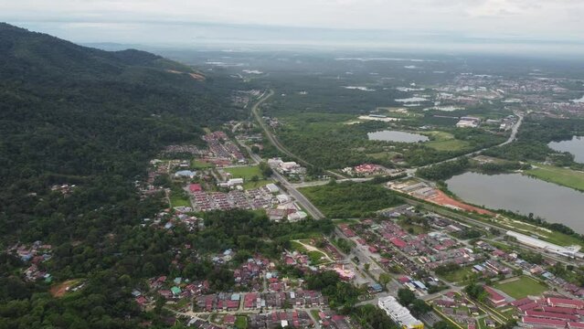 Aerial view panning residential area and abandoned tin mines lake at Kampar, Perak