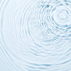 The texture of water on a blue background in bright sunlight.