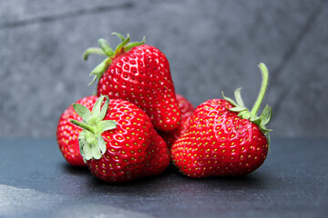Delicious ripe strawberry on grey background