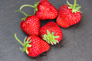 Delicious strawberry on grey stone surface