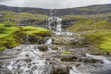 Cascade of waterfalls from beautiful mountains. Faroe Islands. Denmark. Europe. Landscapes.