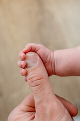 The newborn's hand is in the father's big hand. The concept of protection and love