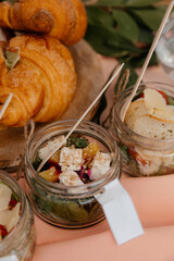 festive salads with beets and oranges against the background of croissants on the festive table