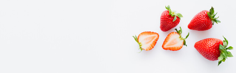 Top view of sweet strawberries on white background with copy space, banner.