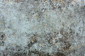 Closeup of a metal surface with rust and cracks.