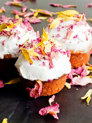 Cake with edible flowers and whipped cream. Shallow dof .