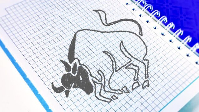 The zodiac sign Taurus to the horoscope is drawn using pencil lines on a paper notebook in a cage. The zodiac sign is gradually drawn with a pencil along the contour, and then painted over.