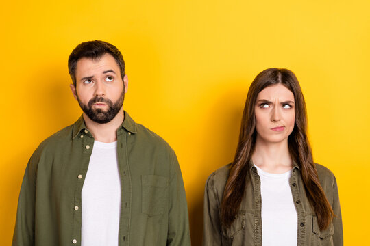 Photo of two minded focused people look interested empty space isolated on yellow color background