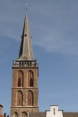 Fototapeta na wymiar Church tower of the medieval Grote or Saint Gudula Church in the center of the Dutch city of Lochem in the Achterhoek.