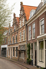 Old historic houses with beautiful facades in the center of the picturesque Dutch town of Oudewater.